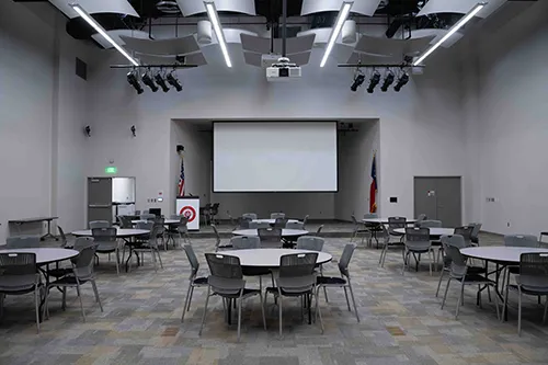 Rundell Hall Conference Center Interior, lectern view: Round tables with chairs