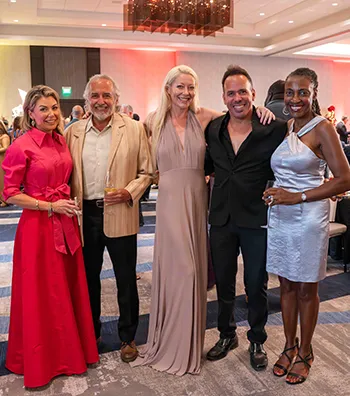 Five people pose for a photo