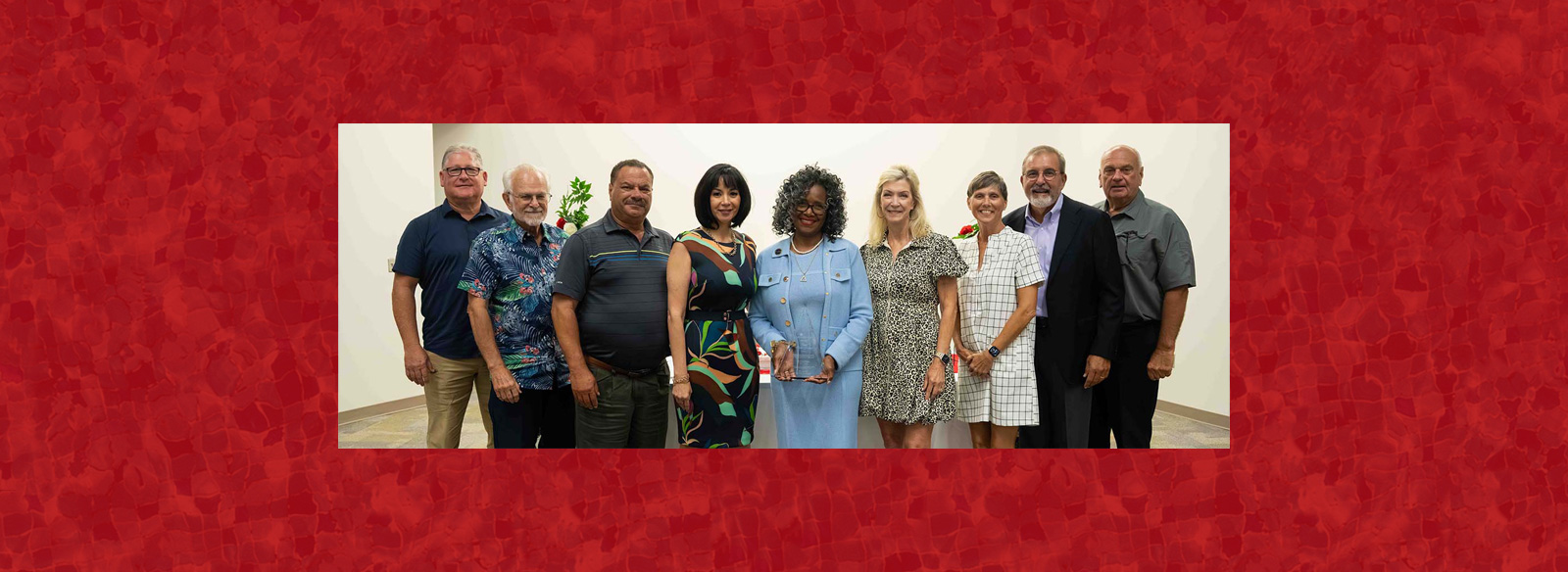 Former Regent Susan Moore-Fontenot holds an award and stands beside Regents Gilbert Santana, Weston Cotten, Daryl Fontenot, President Dr. Lynda Villanueva, Regents Pam Warford, Judy Jerrels, Mark Hall and Mark Himsel  