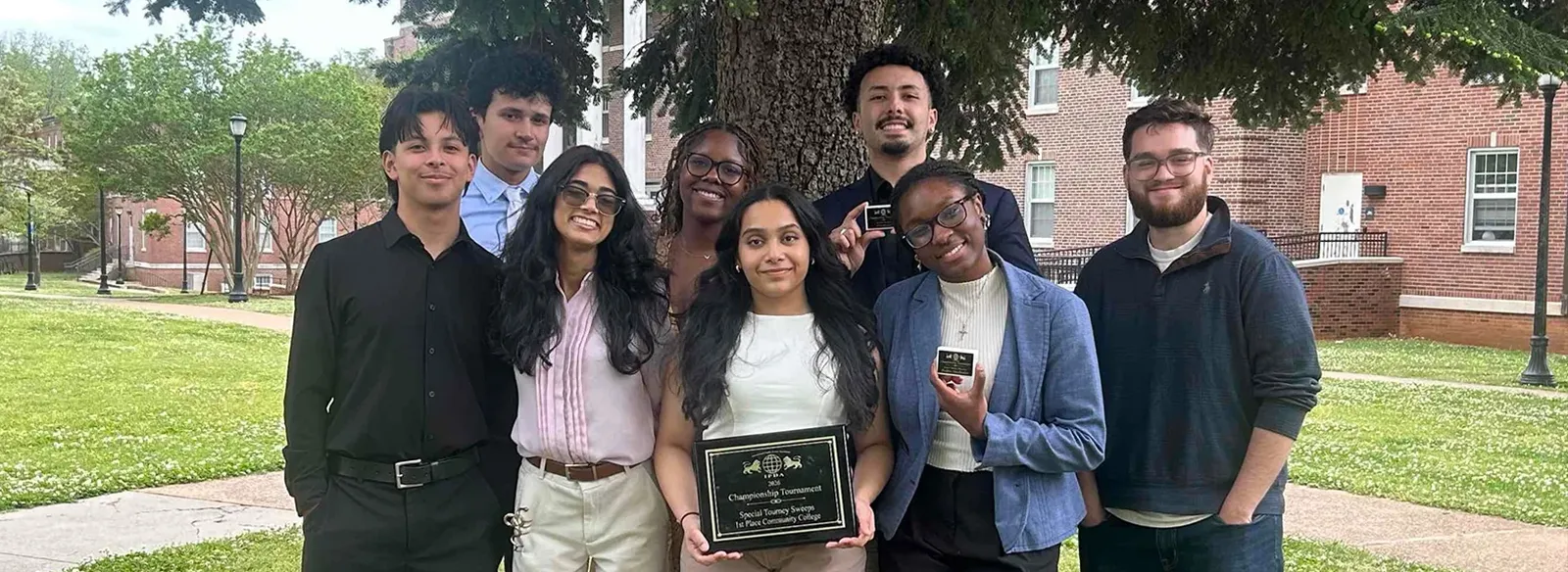 The Lee College debate team poses with their awards.