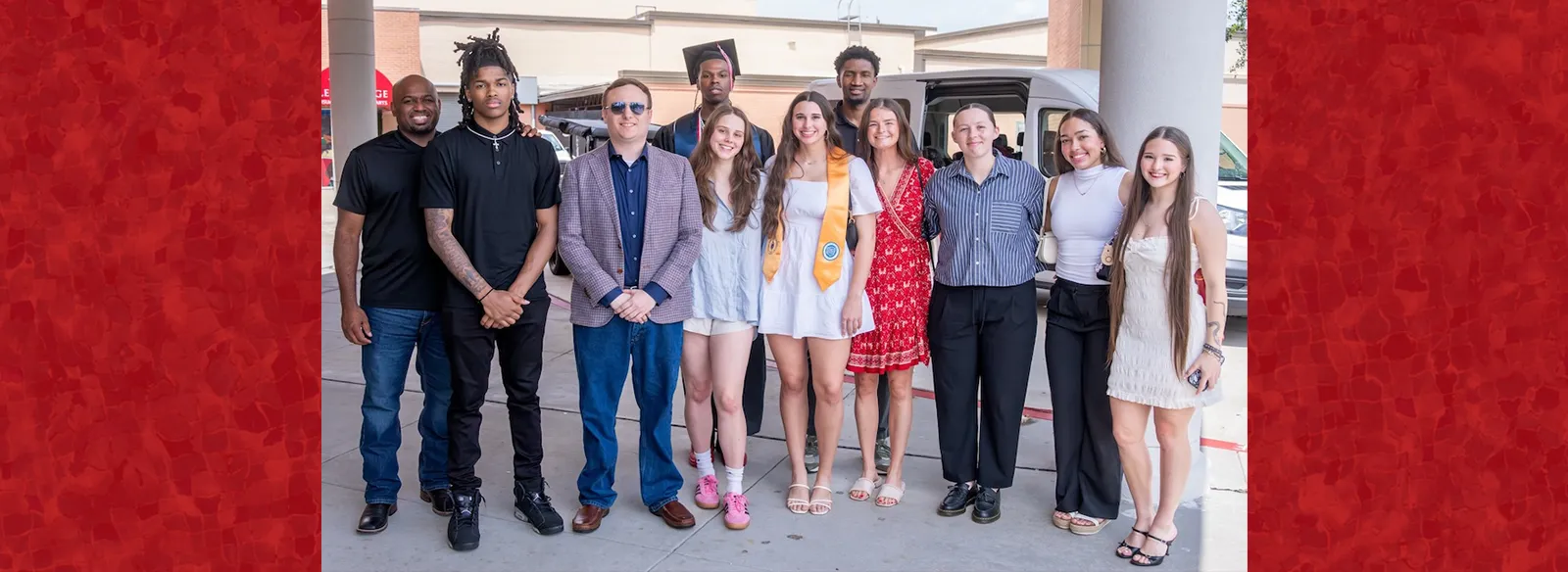 Lee College student athletes and coaches stand outside the Performing Arts Center after graduation ceremonies. 