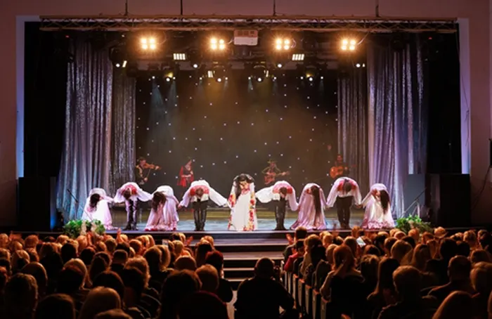 Actors on a stage taking a bow before an audience