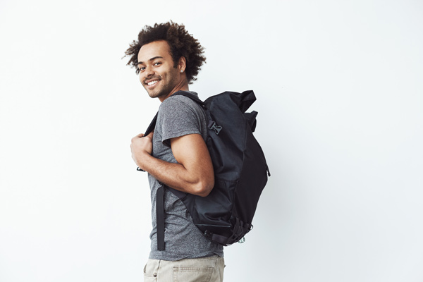 A smiling student with a backpack